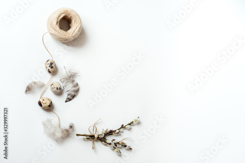 quail eggs and feathers on white background