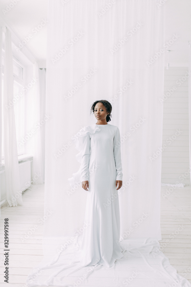 Minimalistic wedding series in European style. Stylish African bride. Concept and idea of a white wedding. Minimalistic wedding series in European style. Stylish African bride. Concept and idea of a white wedding.