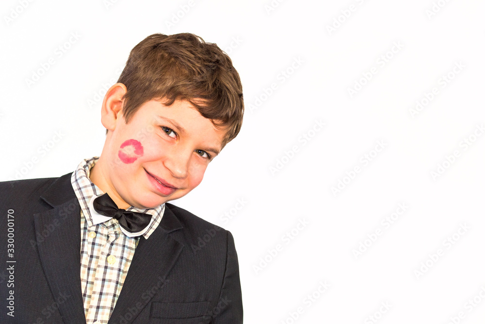 portrait of a teenager boy with the imprint of lips on a cheek isolated on white background portrait of a teenager boy with the imprint of lips on a cheek isolated on white background