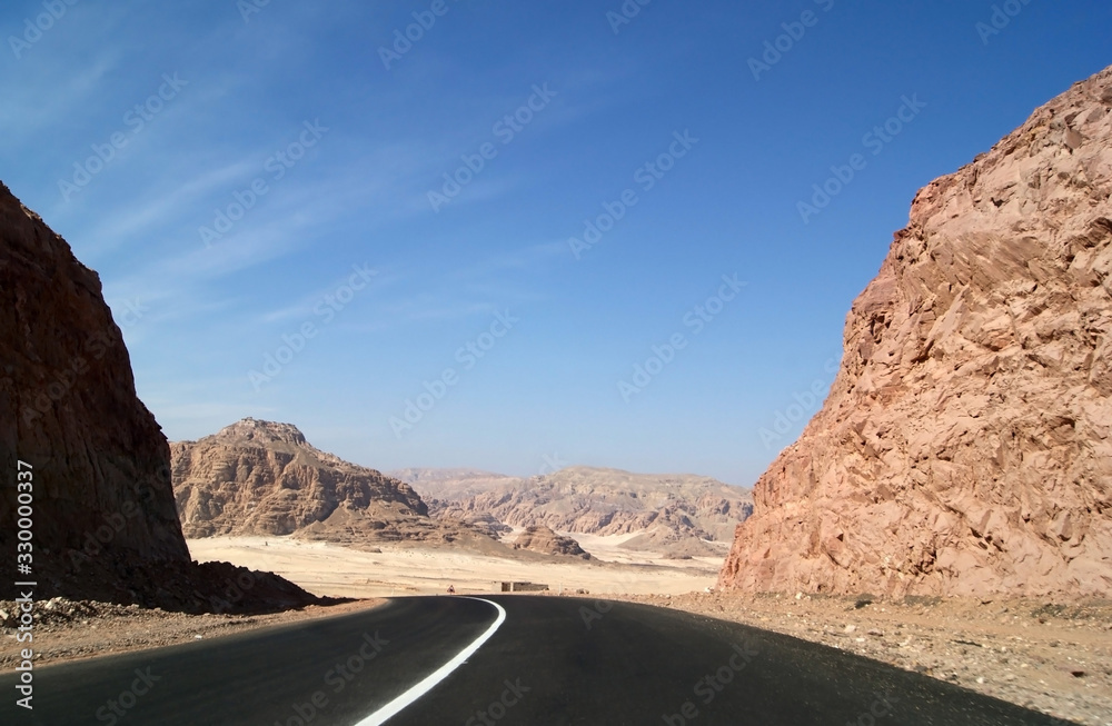 Panorama of the Sinai desert with an asphalt road. The mountains and Sands Panorama of the Sinai desert with an asphalt road. The mountains and Sands