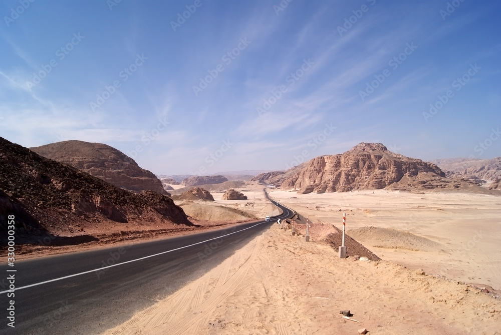 Panorama of the Sinai desert with an asphalt road. The mountains and Sands