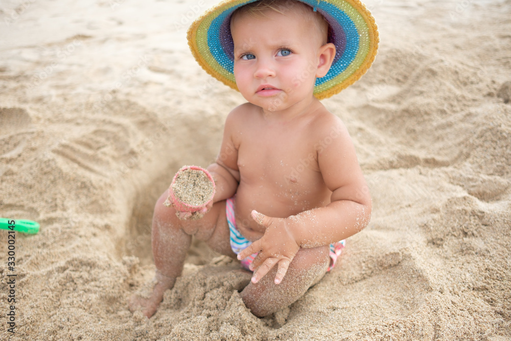 cute little girl playing with sand on tropical beach cute little girl playing with sand on tropical beach