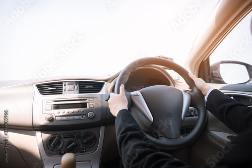 Woman driving her car, hands holding steering wheel. © C_Production