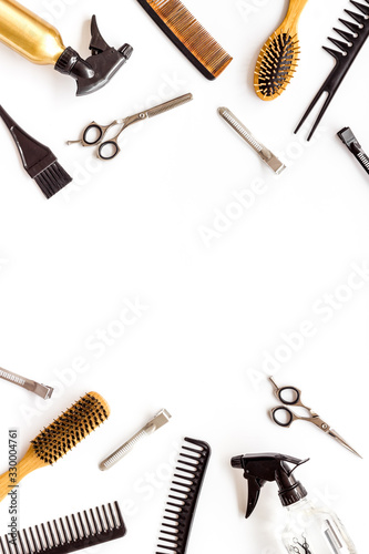 Beauty saloon accessories - combs, sciccors for hairdressing - on white background top-down frame copy space