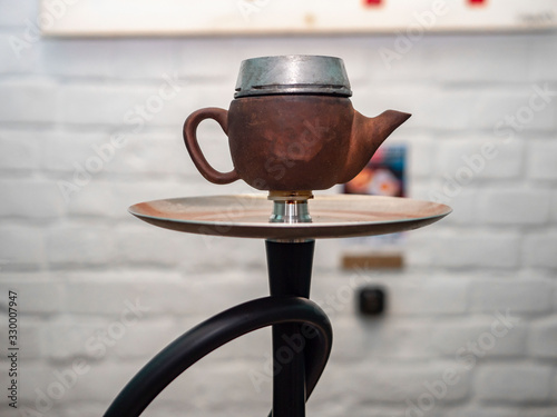 New hookah on a table in an oriental cafe. A variety of flavors of tobacco.