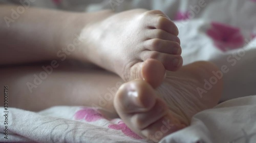 Feets woman on bed comfortable relax.Close up