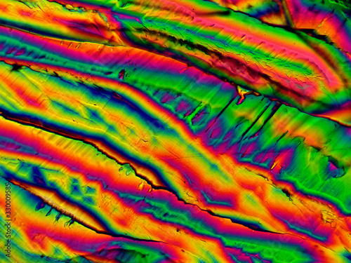 Crystal layer on microscope object glass  seen in polarized light. This causes random unforeseeable color effects.