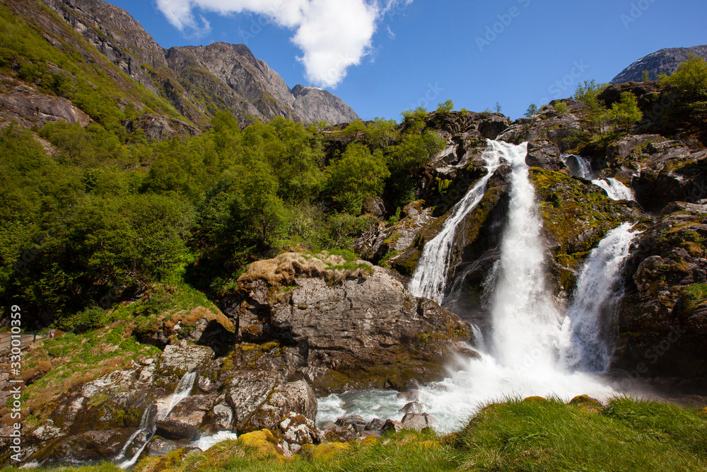 Fototapeta premium Waterfall from the Briksdalsbreen Glacier, the most popular in Norway