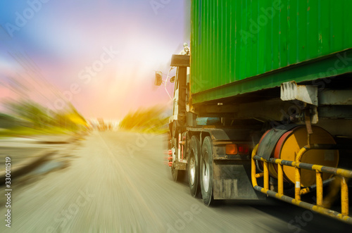 Container truck with green container in blur radial background, image in import export concept