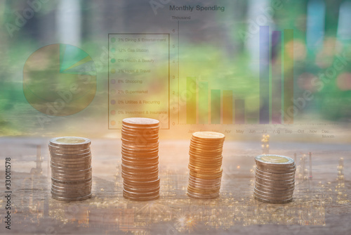 Double exposure of bar and pine graph and rows of coins with refinery exposure for saving , finance and business concept