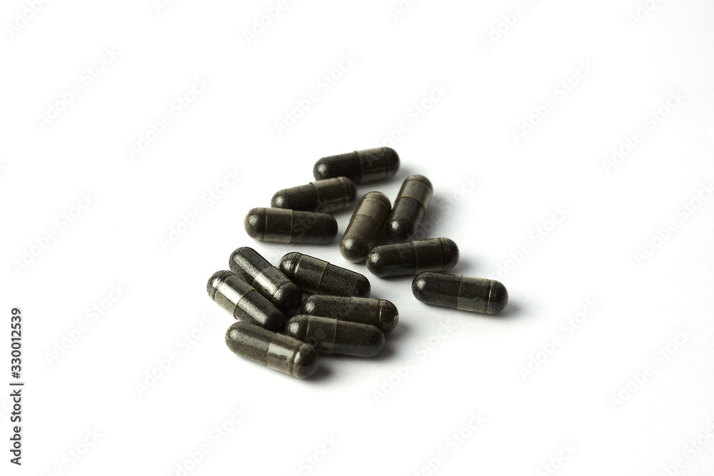 capsule of Nigella sativa ( black caraway, black cumin, black seed ), herbal capsules from habbatussauda isolated on white background. capsule of Nigella sativa ( black caraway, black cumin, black seed ), herbal capsules from habbatussauda isolated on white background.