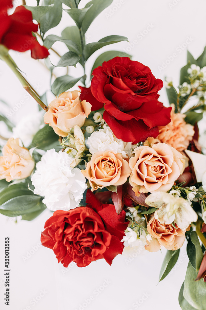 Decor of a stylish wedding ceremony. The decoration of the arch with red roses and wedding floristry. Modern trends in wedding bouquets. Decor of a stylish wedding ceremony. The decoration of the arch with red roses and wedding floristry. Modern trends in wedding bouquets.