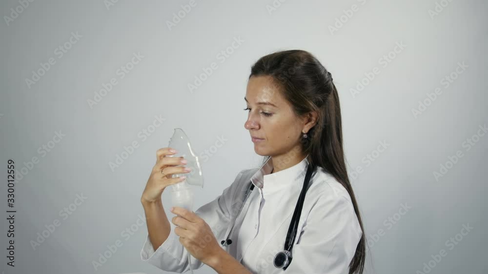 Doctor set up a nebulizer and demonstrates how it works Doctor set up a nebulizer and demonstrates how it works