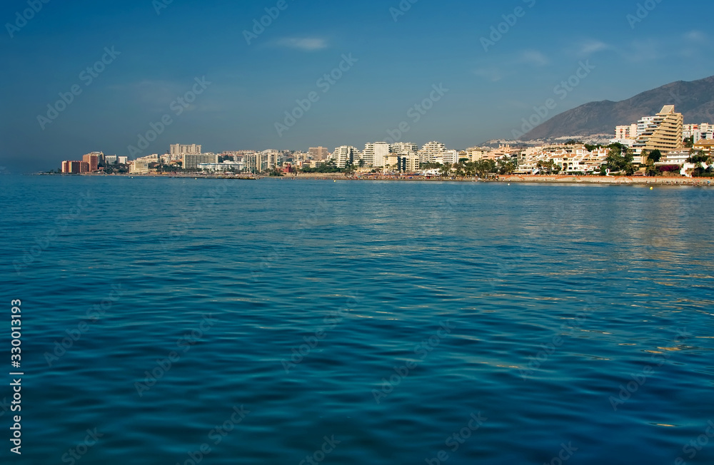 View from the sea ship to the city near the mountains