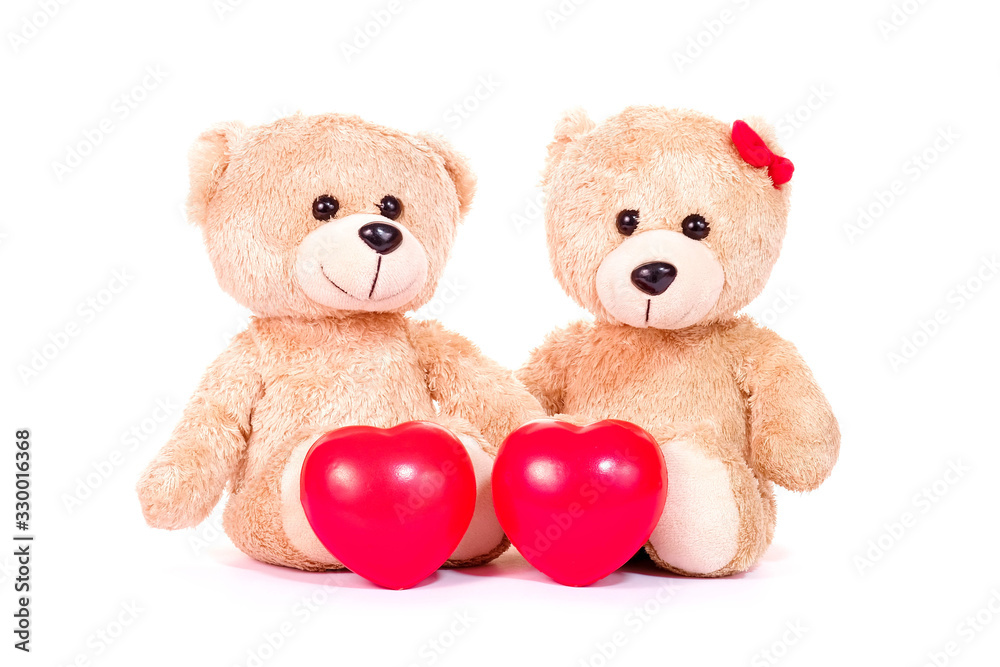 Fototapeta premium Red heart and two teddy bears sit on white background. Love and relationship concept. Valentines concept.