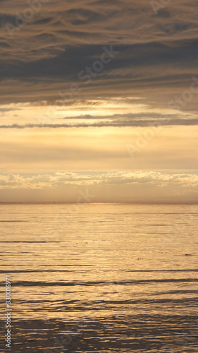 Yellow sunset on the Arctic Ocean in dark tones