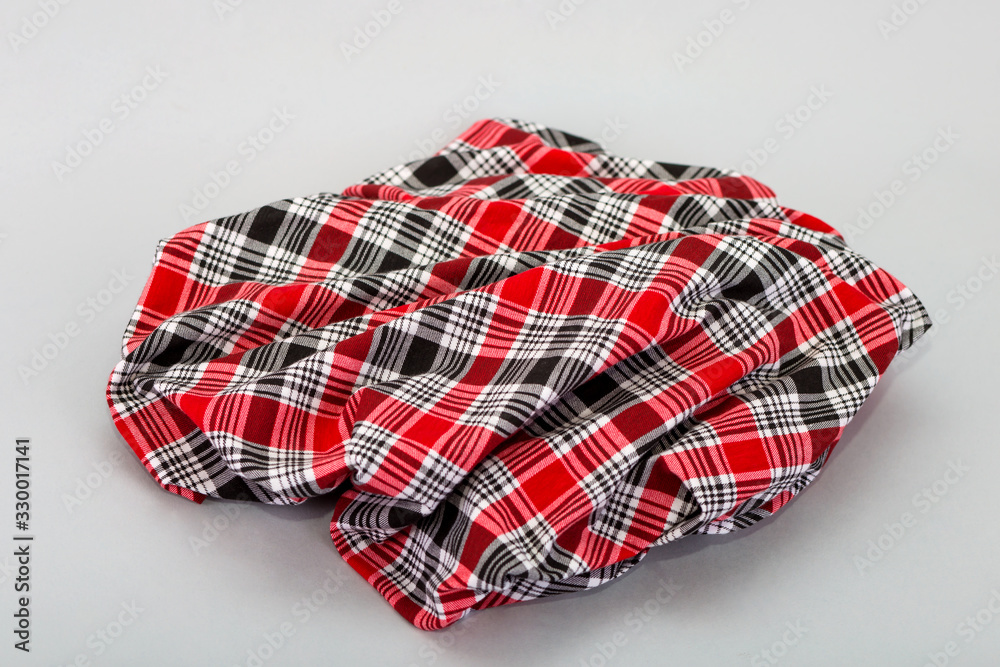 Red checkered fabric. Black and red checkered Scottish model. Textiles from plaid, tablecloths, clothes, shirts, dresses. Red checkered fabric. Black and red checkered Scottish model. Textiles from plaid, tablecloths, clothes, shirts, dresses.