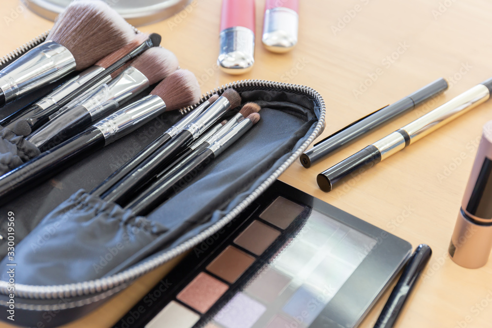 Many make-up cosmetics on the wooden table Many make-up cosmetics on the wooden table