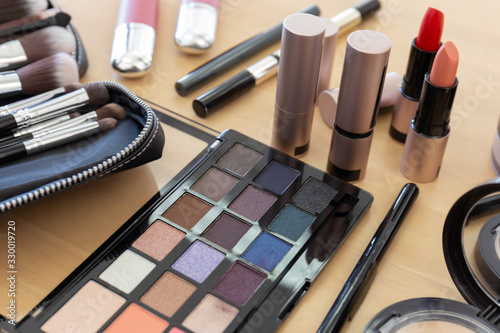 Many make-up cosmetics on the wooden table