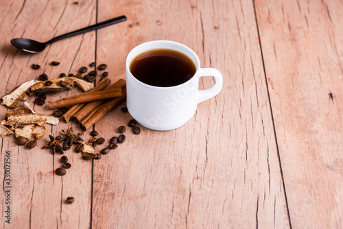 Fragrant natural coffee with cinnamon sticks and a black spoon.