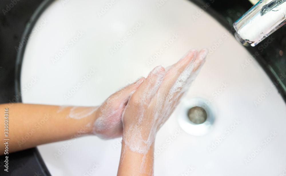 Coronavirus and Covid-19 concept.Kid girl washing hands with soap under the faucet with water in bathroom at home.Stop corona virus outbreak.Coronavirus and epidemic virus symptoms.Step by Step. Coronavirus and Covid-19 concept.Kid girl washing hands with soap under the faucet with water in bathroom at home.Stop corona virus outbreak.Coronavirus and epidemic virus symptoms.Step by Step.