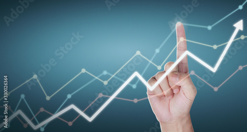 Hand touching graphs of financial indicator and accounting market economy analysis chart