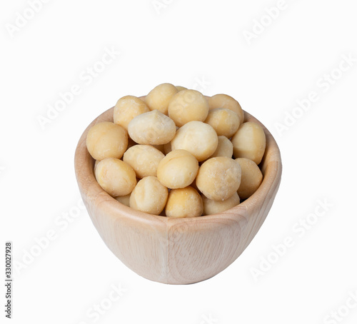 Macadamia in wooden bowl  isolate background