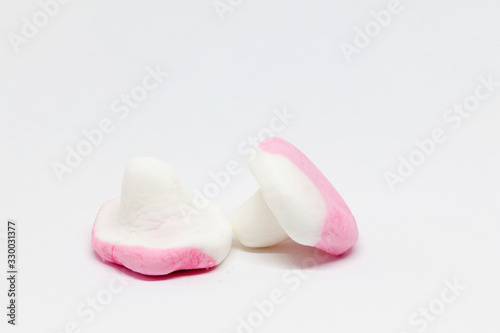 two candy mushrooms in pink and white