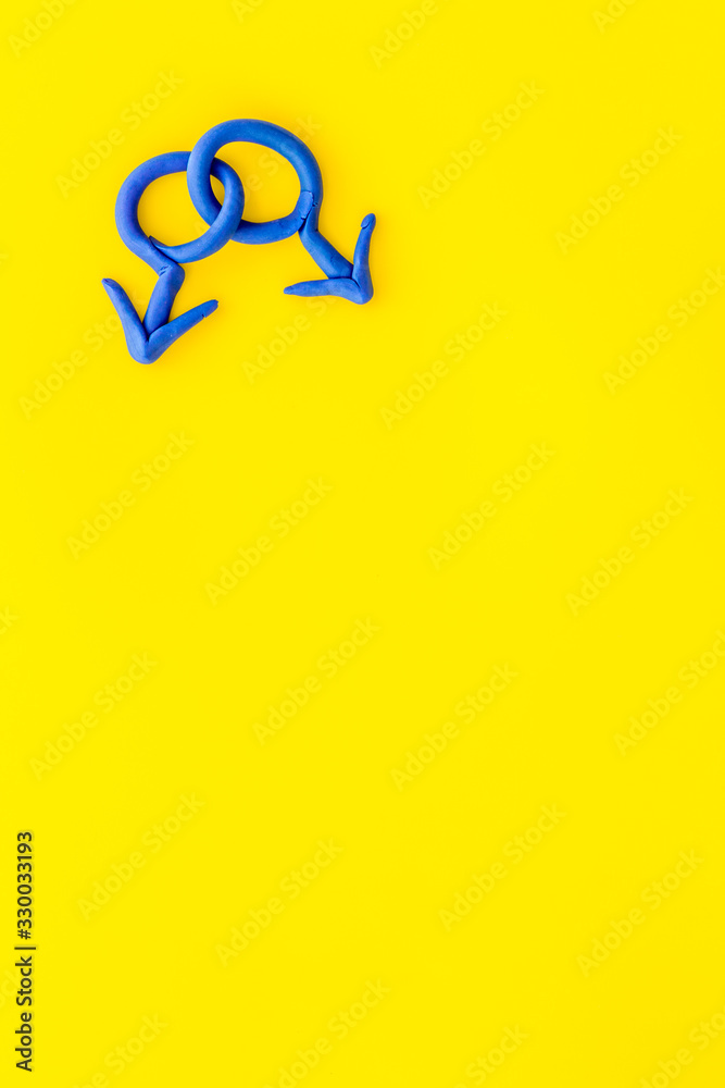 LGBT concept. Male Mars symbol on yellow background top-down copy space LGBT concept. Male Mars symbol on yellow background top-down copy space