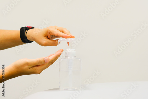 Closeup man using hand press bottle alcohal gel for cleansing, remove and kill bacteria, germ and virus. using for heathcare and sanitary concept with copy space text.