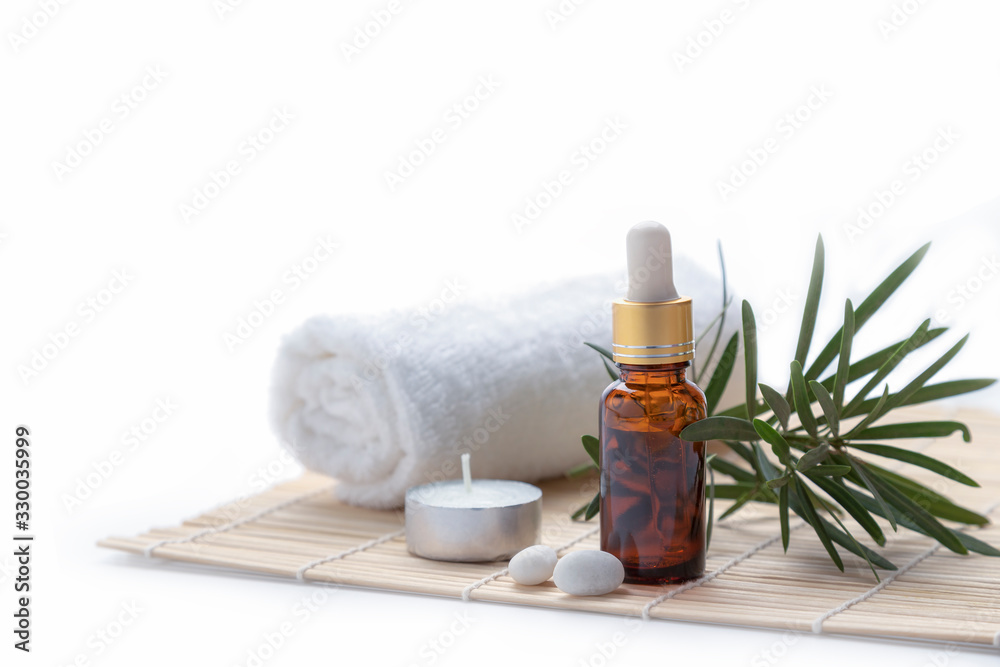 Essential oil with herbs and candle on white background. Essential oil with herbs and candle on white background.
