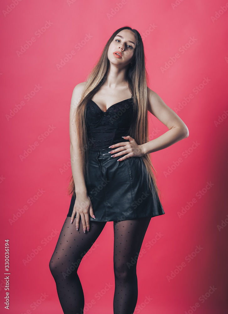 Brunette sexy girl posing at the pink background Brunette sexy girl posing at the pink background