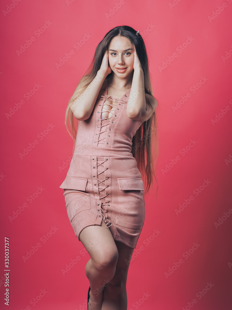 Brunette sexy girl posing at the pink background Brunette sexy girl posing at the pink background