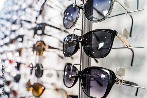 Modern fashionable sunglasses in the shop display shelves