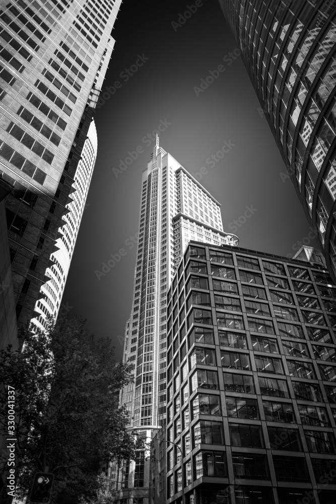 Fototapeta premium Light and shadow -Upwards perspective in black and white of major high rise landmarks in Sydney CBD, Australia.