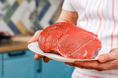 Raw beef for cooking steak on a white plate