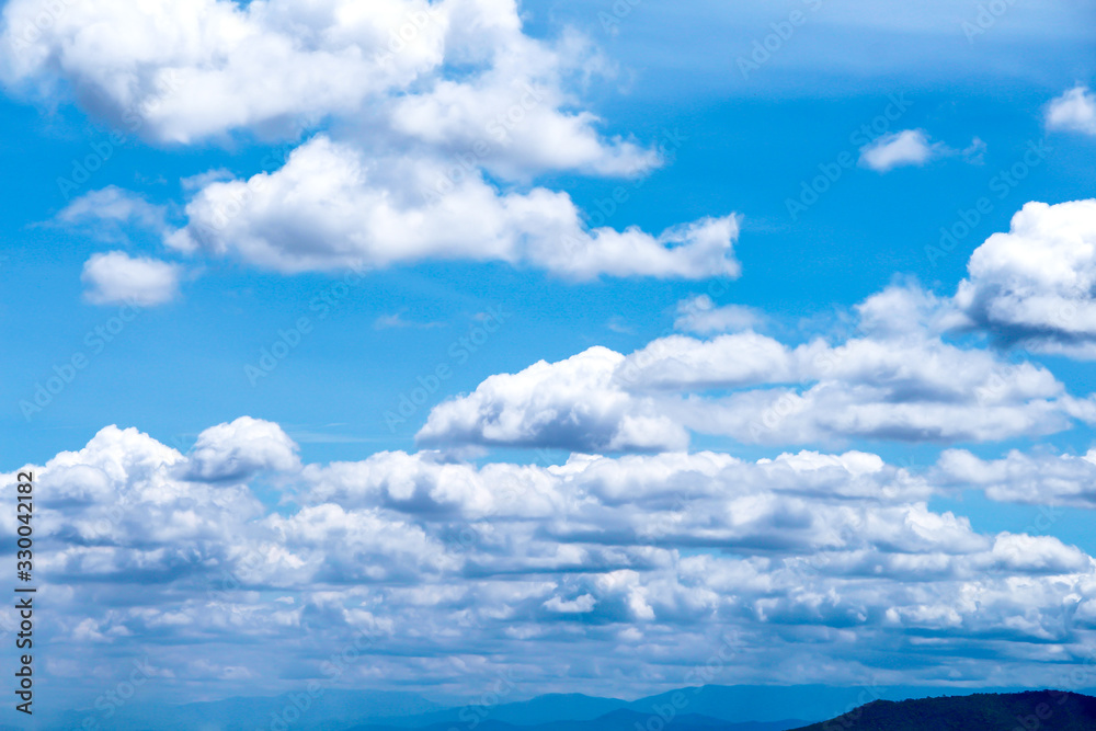 Clouds layer seamless  patterns on bright blue sky over mountains view , summer fresh air background