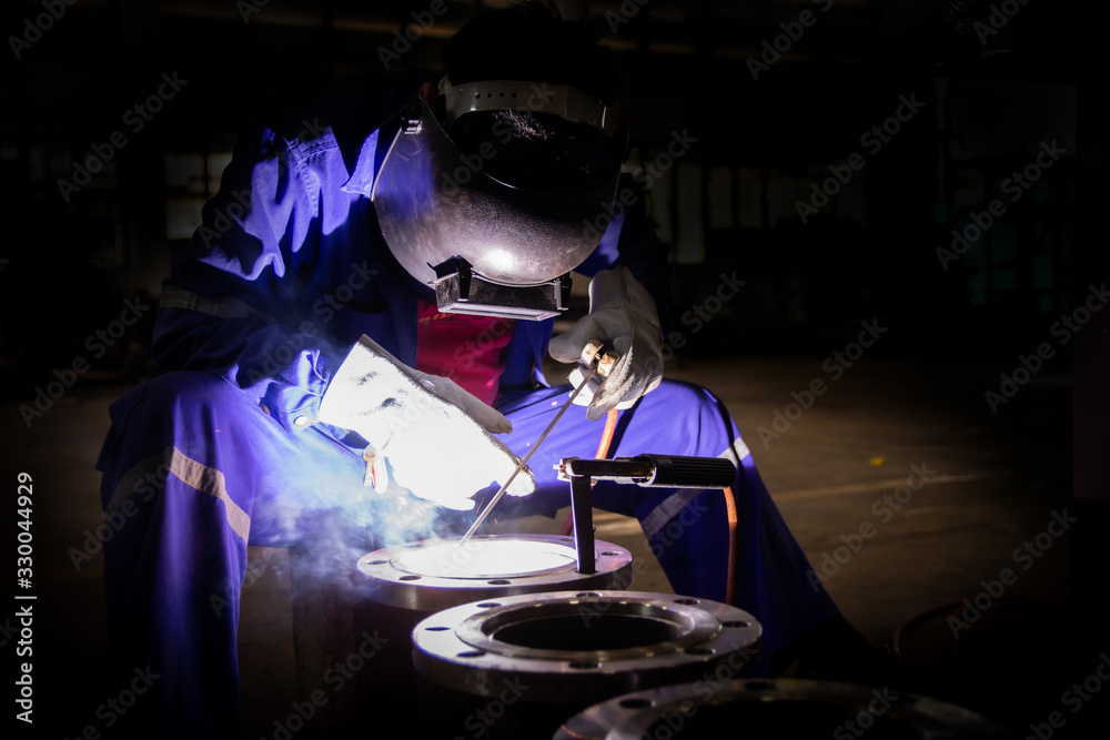 Welder is assembling the workpiece by process shielded metal arc