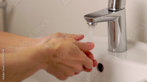 European person washing hands with soap under water and after rinsing its. Concept: coronavirus, health, body care. High quality. 