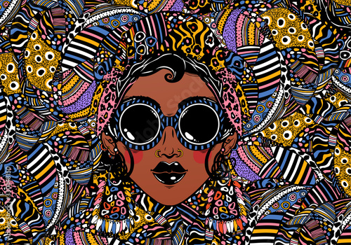 Beautiful African woman in cool urban style with ethnic elegant geometric glasses, earrings on a rythmic background.