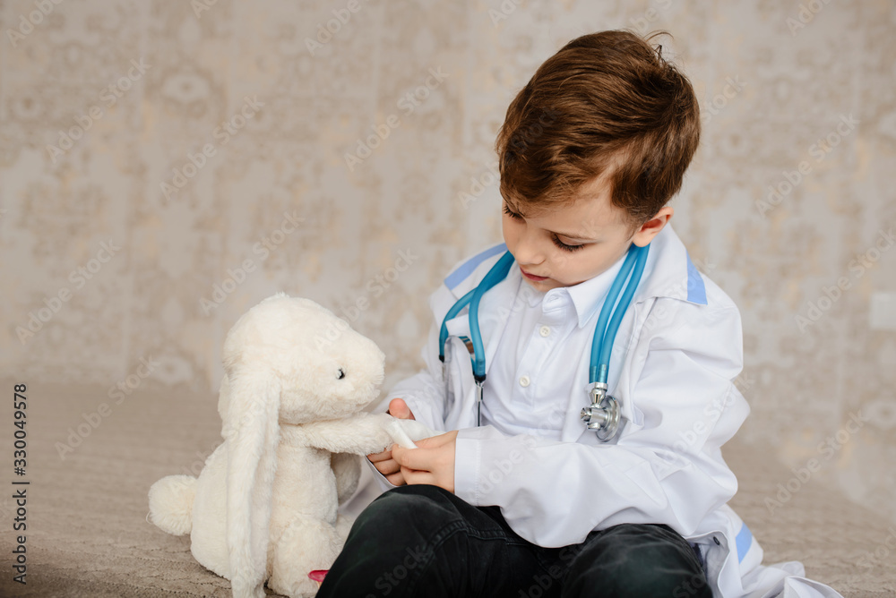 Little boy in white medical robe having fun, Little boy in white medical robe having fun,