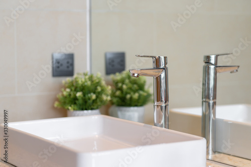 Modern faucet and white ceramic washbasin sink bathroom interior building decoration