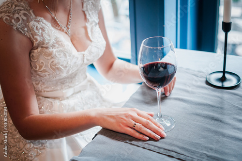 Glass with wred wine in the girls hand photo