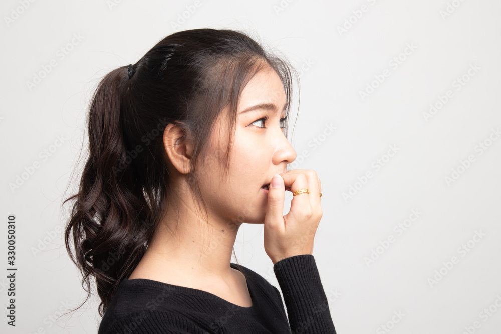Unsure hesitant nervous young asian woman biting her fingernails. Unsure hesitant nervous young asian woman biting her fingernails.