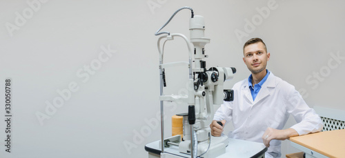 Young beautiful doctor/eye specialist/optometrist in an ophthalmologic clinic