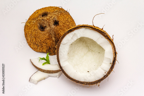Ripe coconut cut on two half isolated on white background