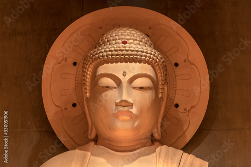 Huge wooden statue of Levitating Daibutsu Buddha Shaka Nyorai created by sculptor Watanabe Seizan in Sengyoji temple of the Nichiren Buddhist sect in Ikebukuro district, Tokyo, Japan. photo