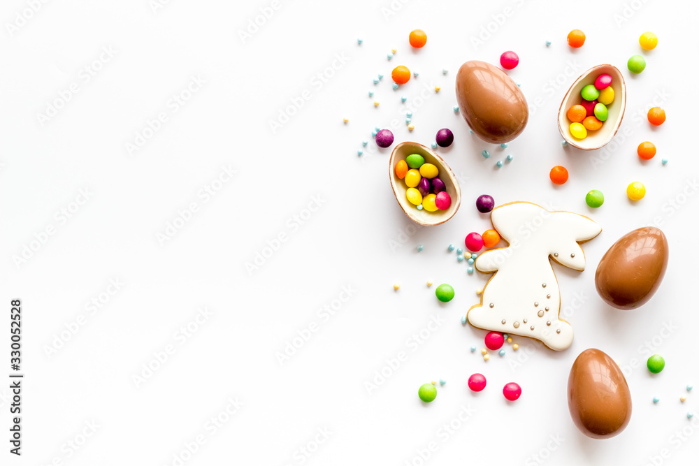 Sweet Easter symbols - chocolate eggs and bunny gingerbread - on white background top-down frame copy space Sweet Easter symbols - chocolate eggs and bunny gingerbread - on white background top-down frame copy space
