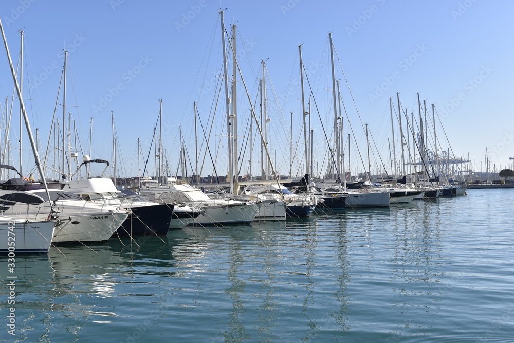 Obraz premium The waters of the port with yachts ,white yacht on blue sea