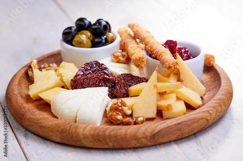 cheese plate with olives and bread sticks
